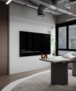 Modern office space in Dubai featuring a curved marble table, wall-mounted screen, potted plant, and large windows—designed by House of Kalaa.