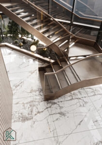Dubai living room featuring a curved staircase with metal railings, marble flooring, decorative planter, and ambient lighting—designed by House of Kalaa.