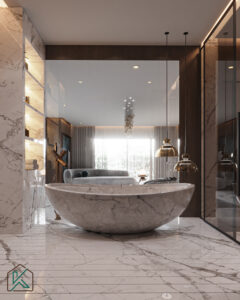 Dubai master bathroom featuring a round marble bathtub, marble flooring, pendant lights, gold fixtures, and a cozy seating area—designed by House of Kalaa.