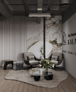 Stylish office lounge featuring marble accent wall, two-tone modern chairs, round coffee table with flowers, and curated decorative elements—by House of Kalaa. Caption: Elegant Dubai office interior by House of Kalaa featuring sculptural seating, veined marble backdrop, and curated décor in a cozy reception nook. Description: This refined office lounge by House of Kalaa brings together rich materials and artful composition. Two modern armchairs with contrasting upholstery surround a round coffee table adorned with fresh flowers, set against a statement marble wall and wood-paneled accents. A sculptural stool and curated décor complete the ambiance, offering inspiration for “luxury office interiors Dubai,” “designer office lounge UAE,” and “modern marble wall reception spaces.” Would you like this content adapted for a homepage banner, social feature, or printed brochure? I’m here to help shape it to fit your next showcase.