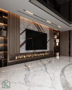 Dubai living room featuring a marble fireplace with linear flame, wall-mounted TV, wood paneling, built-in shelving, and polished marble flooring—designed by House of Kalaa.