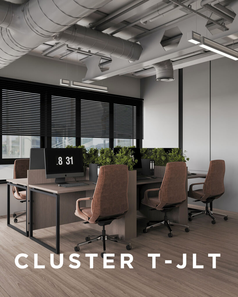 Office interior with four workstations in a cluster layout, brown chairs, desktop monitors, green plant dividers, large windows, and exposed ceiling—designed by House of Kalaa.