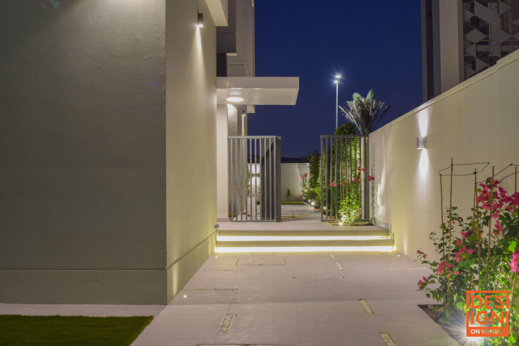 Illuminated modern garden path with greenery, ambient lighting, and architectural elements by Design on Wheels in Dubai.